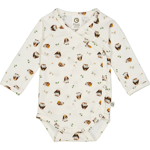 Müsli Bunnies long-sleeved baby bodysuit with a cross closure, rabbit print in neutral colors, and front snap buttons. Made from a cotton jersey fabric.